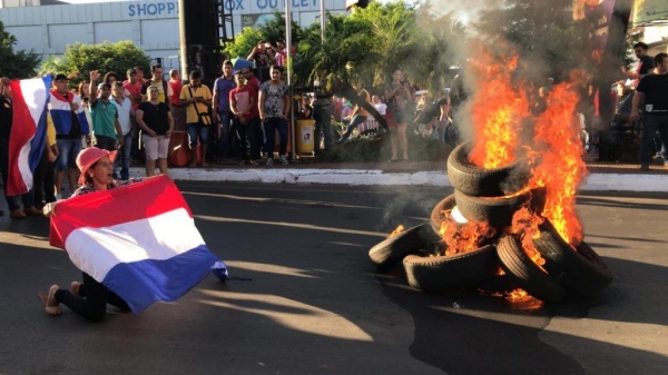 Manifestantes bloquearam ruas e colocaram fogo em pneus no centro de importados de Cidade do Leste, no Paraguai — Foto: Marcos Landim/RPC